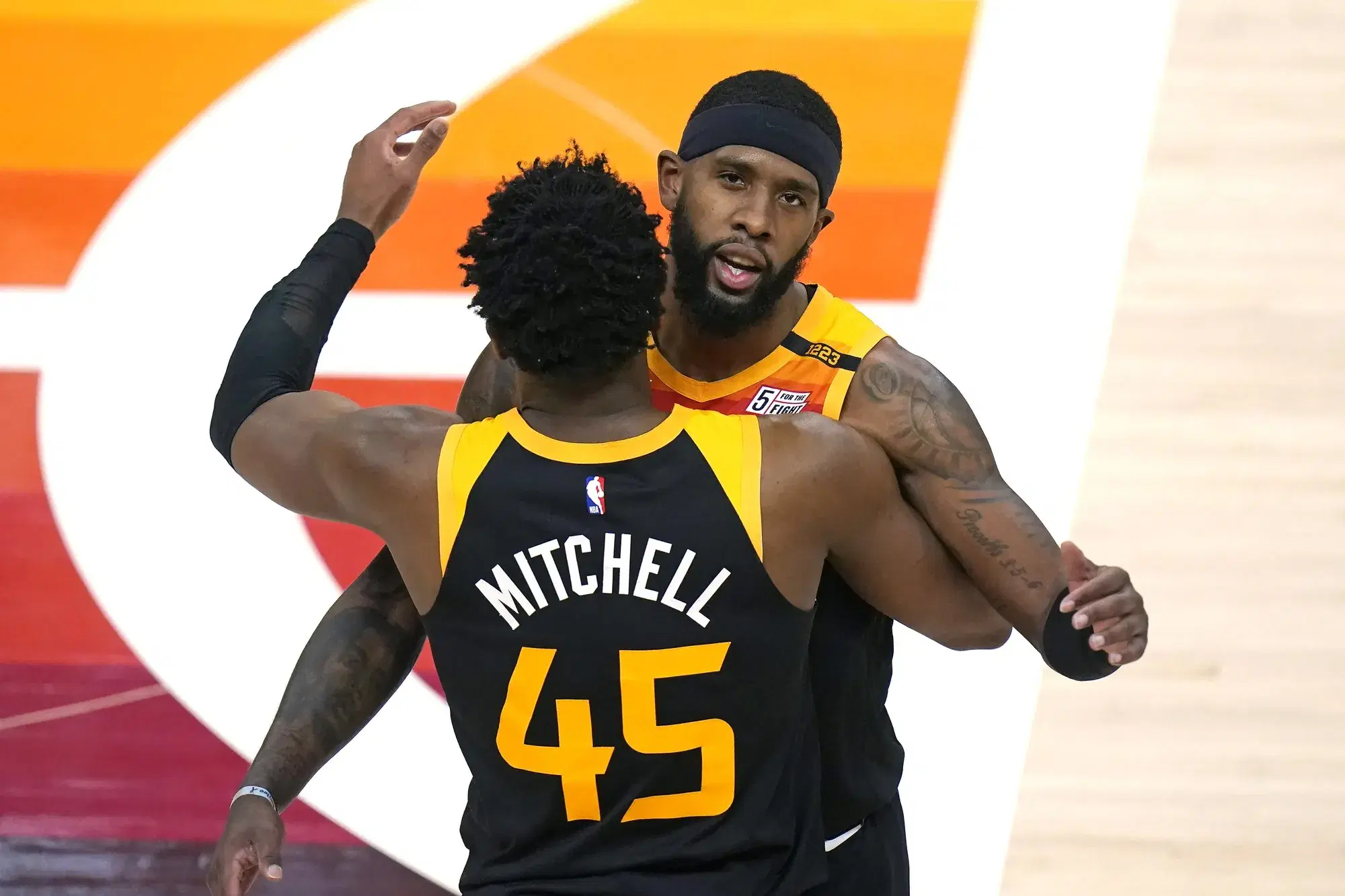 Utah Jazz's Royce O'Neale, rear, and Donovan Mitchell (45) celebrate after their NBA basketball game against the Philadelphia 76ers Monday, Feb. 15, 2021, in Salt Lake City. (AP Photo/Rick Bowmer)