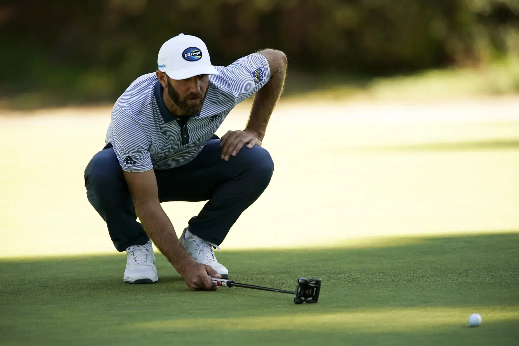 Dustin Johnson lines up his putt on the 13th hole during the final round of the Genesis Invitational golf tournament at Riviera Country Club, Sunday, Feb. 21, 2021, in the Pacific Palisades area of Los Angeles. (AP Photo/Ryan Kang)