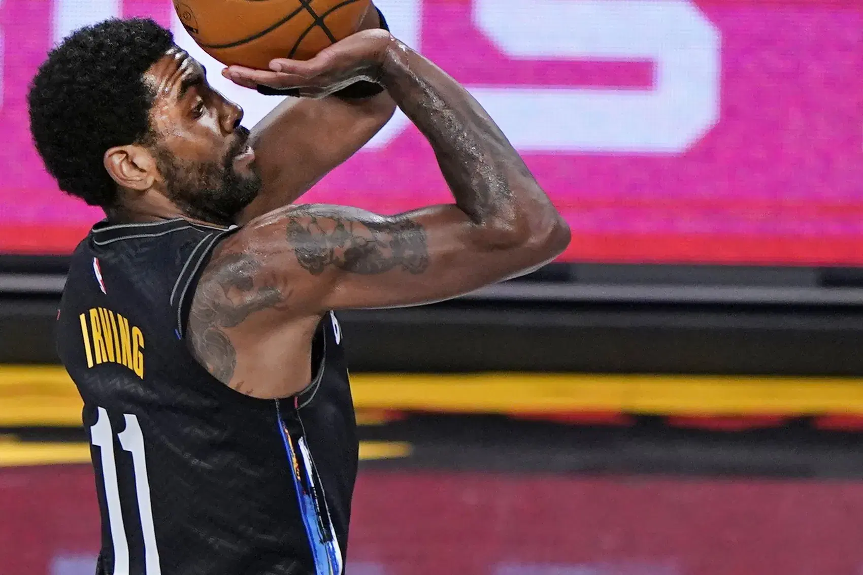 Brooklyn Nets guard Kyrie Irving (11) shoots for three points during the first quarter of an NBA basketball game, Thursday, Feb. 25, 2021, in New York. (AP Photo/Kathy Willens)