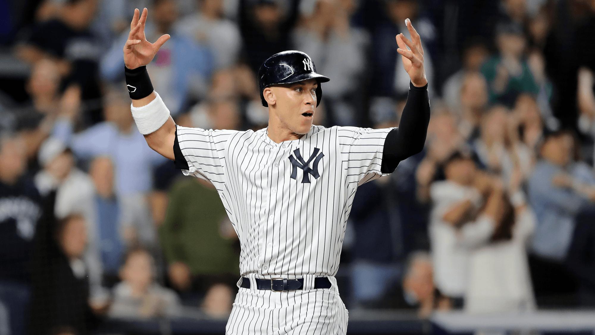 NEW YORK, NEW YORK - OCTOBER 03: Aaron Judge #99 of the New York Yankees celebrates after scoring a run off of a double hit by Aaron Hicks #31 during the sixth inning against the Oakland Athletics in the American League Wild Card Game at Yankee Stadium on October 03, 2018 in the Bronx borough of New York City. (Photo by Elsa/Getty Images)