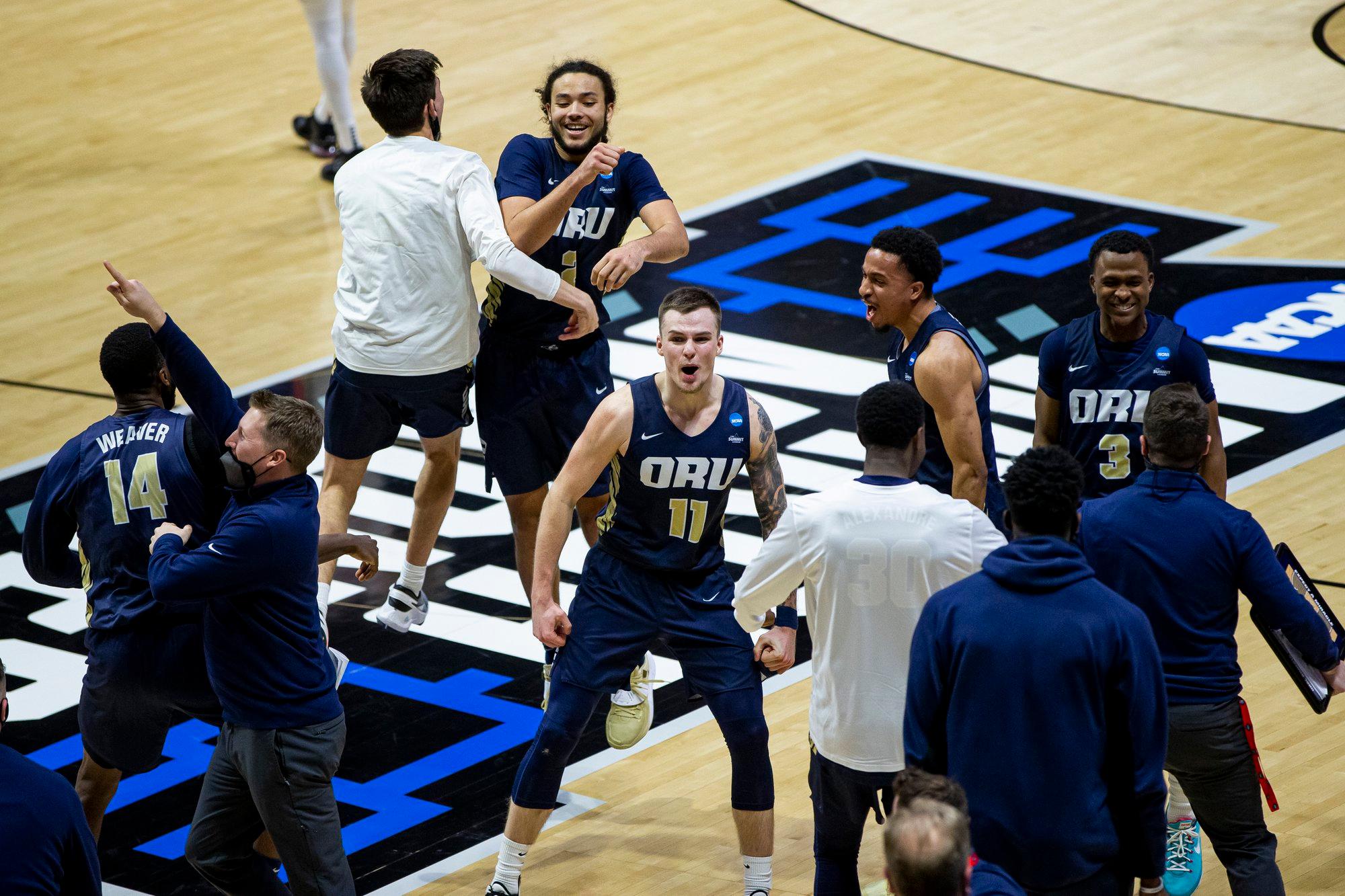 Oral Roberts players and coaches celebrate after beating Ohio State in a first-round game in the NCAA men's college basketball tournament, Friday, March 19, 2021, at Mackey Arena in West Lafayette, Ind. (AP Photo/Robert Franklin)