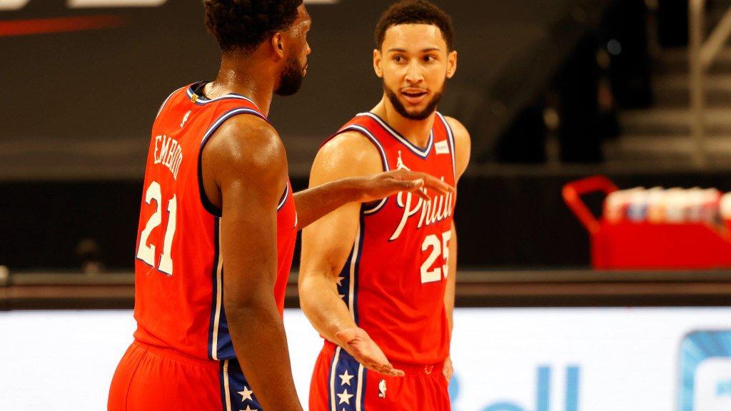 Feb 21, 2021; Tampa, Florida, USA; Philadelphia 76ers center Joel Embiid (21) and guard Ben Simmons (25) talk against the Toronto Raptors during the first quarter at Amalie Arena. Mandatory Credit: Kim Klement-USA TODAY Sports