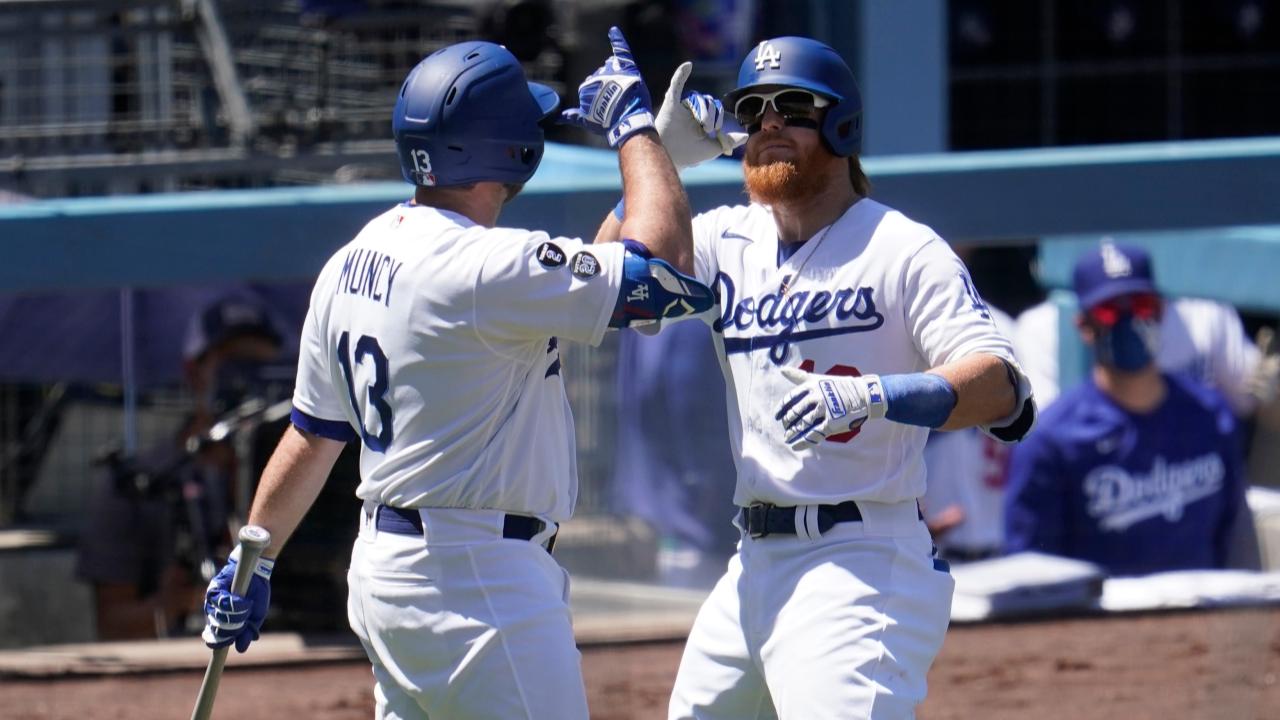 Los Angeles Dodgers' Justin Turner, right, celebrates his solo home run with Max Muncy during the third inning of a baseball game against the Cincinnati Reds Wednesday, April 28, 2021, in Los Angeles. (AP Photo/Marcio Jose Sanchez)