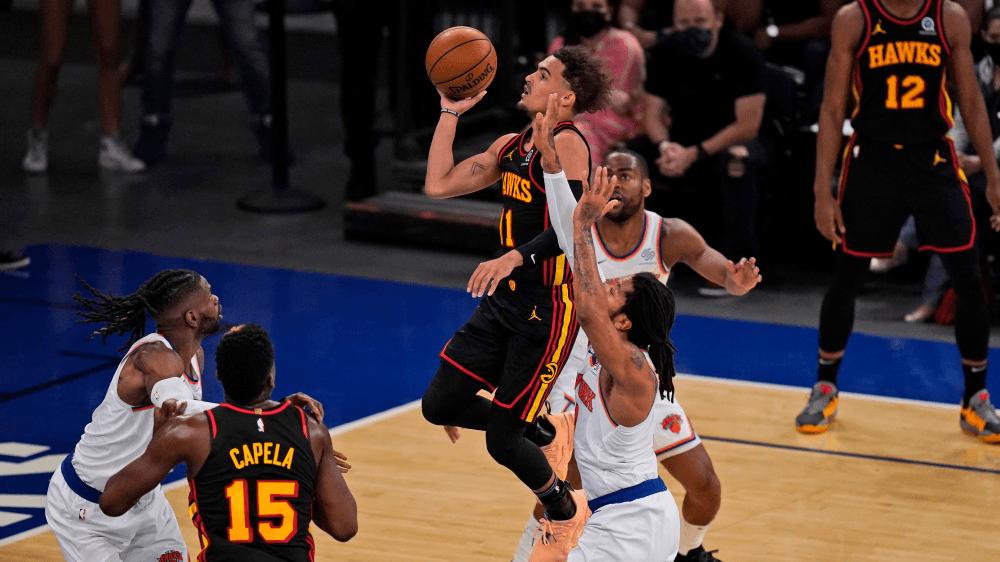Atlanta Hawks' Trae Young, center, drives to the basket during the first half of Game 1 of an NBA basketball first-round playoff series against the New York Knicks, Sunday, May 23, 2021, in New York. (AP Photo/Seth Wenig, Pool) ORG XMIT: NYSW736