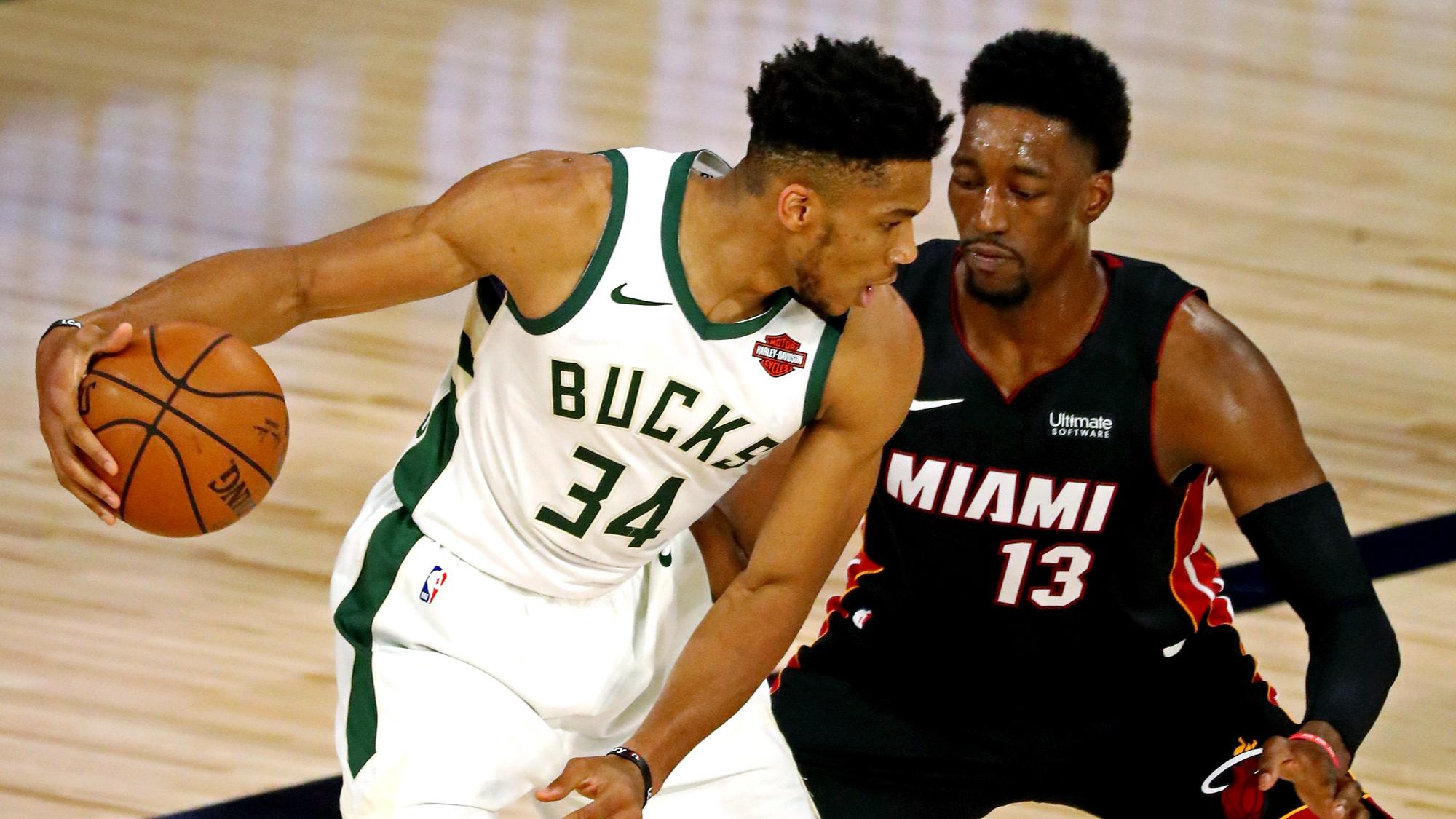 Sep 4, 2020; Lake Buena Vista, Florida, USA; Milwaukee Bucks forward Giannis Antetokounmpo (34) handles the ball against Miami Heat forward Bam Adebayo (13) during the first quarter in game three of the second round of the 2020 NBA Playoffs at ESPN Wide World of Sports Complex. Mandatory Credit: Kim Klement-USA TODAY Sports