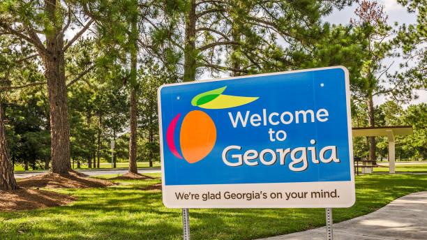 State sign for Georgia welcomes visitors in a shaded rest area