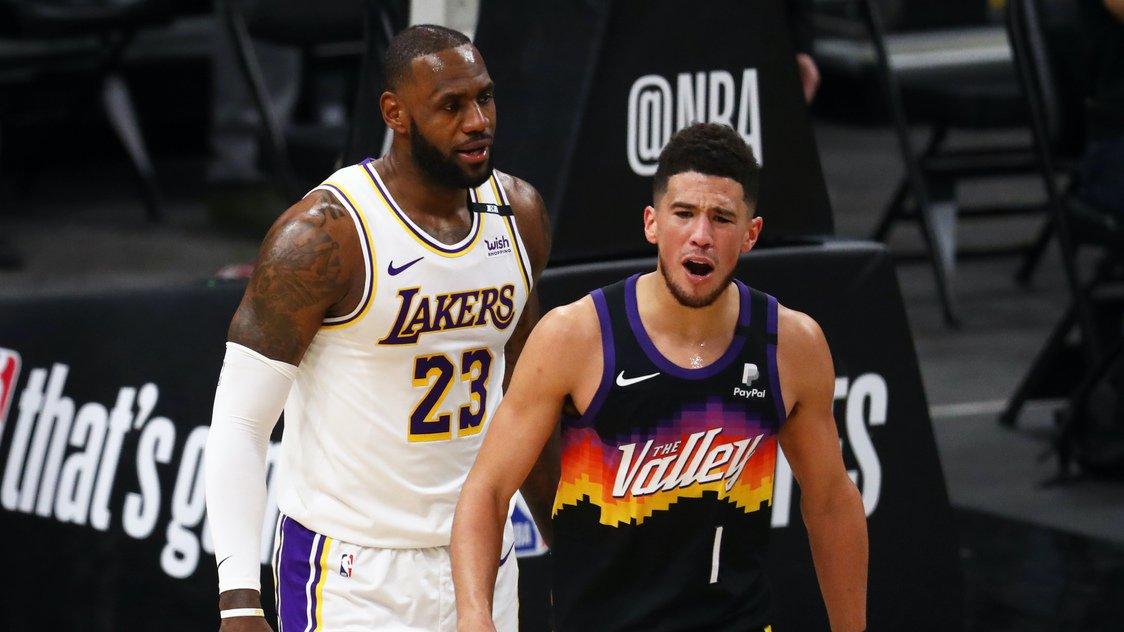 May 23, 2021; Phoenix, Arizona, USA; Phoenix Suns guard Devin Booker (1) reacts alongside Los Angeles Lakers forward LeBron James (23) in the first half during game one in the first round of the 2021 NBA Playoffs. at Phoenix Suns Arena. Mandatory Credit: Mark J. Rebilas-USA TODAY Sports