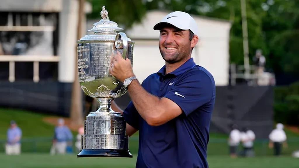 PGA Championship Betting Guide cover (Scottie Scheffler holds up the winner's trophy after winning the 2025 PGA Championship)