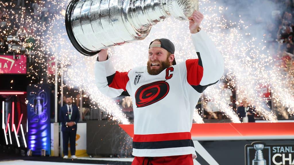 Stanley Cup Betting Guide cover (Carolina Hurricanes captain Jordan Staal lifts the Stanley Cup after the Hurricanes' 2026 title win)