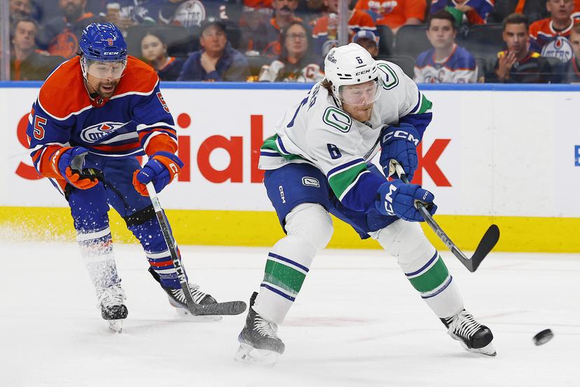 Brock Boeser gets by Cody Ceci.