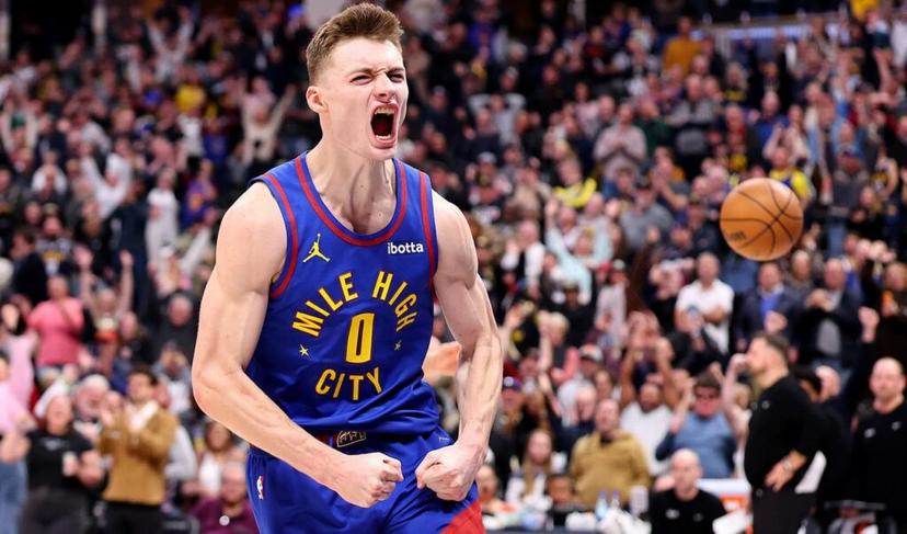 Nuggets NBA Player Flexing in Denver with blue jersey and crowd.