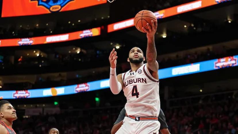 Auburn's Johni Broome (#4 in white) attempts a shot during a game